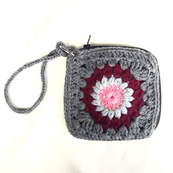 The Sunburst Crochet Wristlet is unique zipper pouch that demands your full attention thanks to the lovely texture and a soft romantic hue.